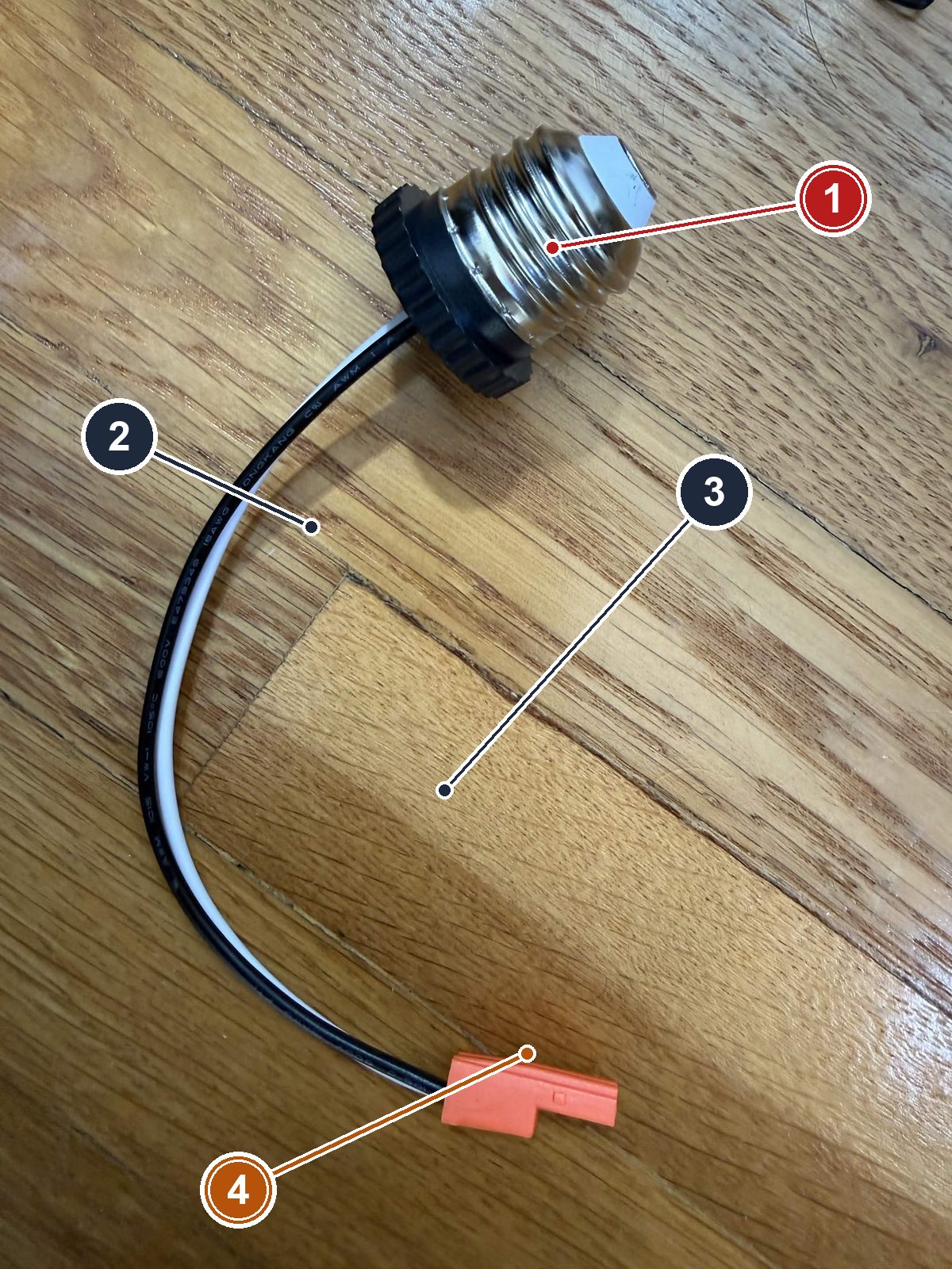 The E26 socket-to-wire adapter: screw base, black and white 18 AWG leads, factory connector on the ends