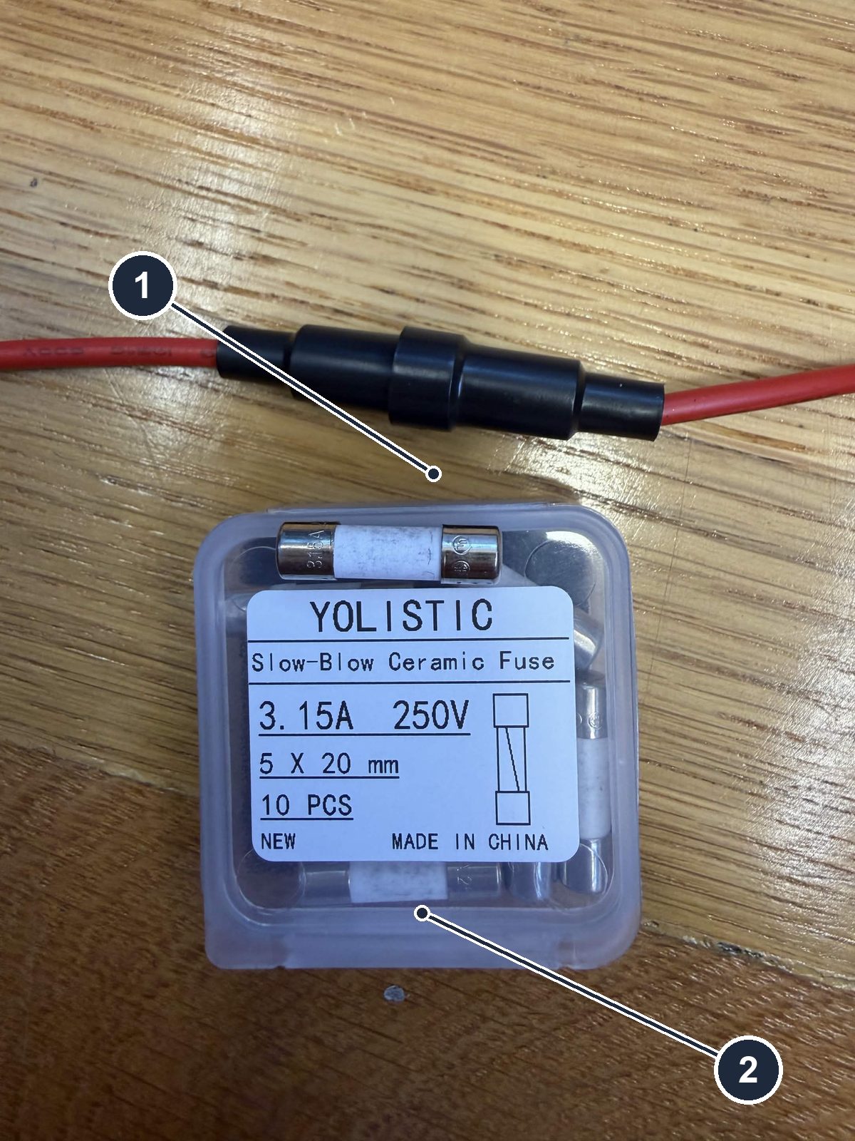 The inline fuse holder on its red leads, and the box of 3.15 A slow-blow ceramic fuses